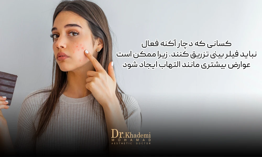 یک دختر خانم جوان است که به آکنه های صورتش اشاره می کند